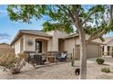 Inviting front porch with comfortable seating area, desert landscaping, and a neutral color scheme at 219 W Canyon Way, San Tan Valley, AZ 85143