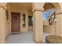 Covered front porch with decorative columns, stylish front door, and welcoming ambiance at 2280 E Aloe Pl, Chandler, AZ 85286