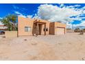 Charming single-story home with light brown stucco and low-maintenance desert landscaping at 26015 S Grapefruit Dr, Queen Creek, AZ 85142