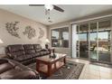 Inviting living room with tile floors, a sliding glass door, and neutral-toned walls at 30444 N Bismark St, San Tan Valley, AZ 85143