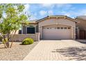 Charming home features a desert-friendly front yard with stone accents and a paved driveway at 4121 W Bradshaw Creek Ln, New River, AZ 85087