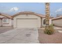 Single-story home with a tile roof, two-car garage, and low-maintenance desert landscaping at 4545 N 67Th Ave # 1106, Phoenix, AZ 85033