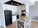 Bright kitchen featuring stainless steel appliances, white cabinetry, and a stylish kitchen island at 4750 N Central Ave # 3B, Phoenix, AZ 85012