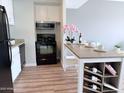 Bright kitchen featuring stainless steel appliances, white cabinetry, and a stylish kitchen island at 4750 N Central Ave # 3B, Phoenix, AZ 85012