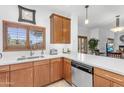 Charming kitchen with quartz countertops, wood cabinets, stainless dishwasher, and natural light at 5350 E Deer Valley Dr # 1419, Phoenix, AZ 85054