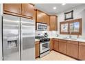 Well-equipped kitchen showcasing stainless steel appliances, modern fixtures, and wood cabinetry at 5350 E Deer Valley Dr # 1419, Phoenix, AZ 85054