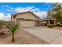 Well-maintained home with a two-car garage and low-maintenance desert landscaping at 606 S 124Th Ave, Avondale, AZ 85323