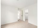 Clean bedroom with neutral carpet and walls featuring a walk-in closet and ample lighting at 7056 W Caron Dr, Peoria, AZ 85345
