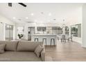 Open floor plan boasting a kitchen island with bar seating, stainless steel appliances, and neutral tones at 7056 W Caron Dr, Peoria, AZ 85345