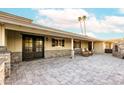 Charming home with a stone accent wall, covered porch, and outdoor seating area at 7417 E Bonita Dr, Scottsdale, AZ 85250