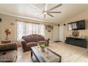 Spacious living room with tile flooring, decorative curtains, and a view to the front door at 8531 N 37Th Ave, Phoenix, AZ 85051