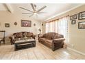 Cozy living room featuring tile floors, a ceiling fan, and comfortable seating at 8531 N 37Th Ave, Phoenix, AZ 85051