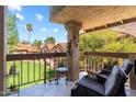 Relaxing balcony with chairs overlooking a green lawn and neighborhood with red tile roofs at 8700 E Mountain View Rd # 2058, Scottsdale, AZ 85258