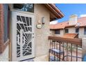 Inviting condo entrance with decorative door, 'Welcome' sign, and small table with chairs at 8700 E Mountain View Rd # 2058, Scottsdale, AZ 85258