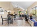 Bright living room with tile floors, vaulted ceilings, and a dining area adjacent to the living space at 8700 E Mountain View Rd # 2058, Scottsdale, AZ 85258