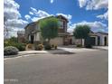 Attractive two-story home showcases a landscaped front yard, two-car garage, and a welcoming covered porch at 9207 W Sells Dr, Phoenix, AZ 85037