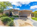 Inviting exterior of home featuring a lush lawn, desert landscaping, and driveway at 9475 N 115Th Pl, Scottsdale, AZ 85259