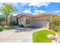 Stunning single-story home featuring a tile roof, desert landscaping, and a paved driveway at 9475 N 115Th Pl, Scottsdale, AZ 85259