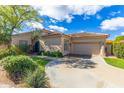 Charming single-story home featuring a tile roof, desert landscaping, and attached two car garage at 9475 N 115Th Pl, Scottsdale, AZ 85259