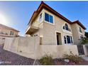 Exterior view of a two-story townhome featuring a private balcony and desert-friendly landscaping at 10249 N 12Th Pl # 2, Phoenix, AZ 85020