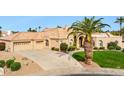 Attractive single story home with tile roof, desert landscaping, and a long driveway to a 3 car garage at 11216 E Appaloosa Pl, Scottsdale, AZ 85259