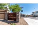 View of the 'Willis Commons' neighborhood sign surrounded by lush green landscaping at 1193 E Spruce Dr, Chandler, AZ 85286