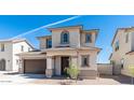 Charming two-story home featuring a covered entryway, neutral stucco, and a two-car garage at 1193 E Spruce Dr, Chandler, AZ 85286