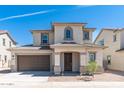 Charming two-story home featuring a covered entryway, neutral stucco, and a two-car garage at 1193 E Spruce Dr, Chandler, AZ 85286