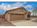 Charming single-story home featuring a two-car garage and low maintenance desert landscaping at 121 N Ramada --, Mesa, AZ 85205