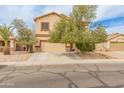 Traditional home featuring manicured landscaping, neutral tones, and a large driveway at 14450 N 132Nd Dr, Surprise, AZ 85379