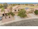 Lovely home with a tile roof and solar panels, situated near a park at 14450 N 132Nd Dr, Surprise, AZ 85379