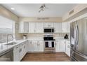 Bright kitchen with stainless steel appliances, modern cabinets, ample counter space, and a sink with window views at 16157 W Moreland St, Goodyear, AZ 85338