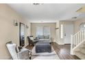 Inviting living room featuring comfortable seating, neutral tones, and easy access to the staircase at 16157 W Moreland St, Goodyear, AZ 85338