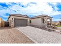 Stylish home featuring a paved driveway, stone accents, and a two-car garage at 16517 S 7Th Pl, Phoenix, AZ 85048