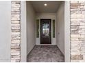 Inviting entryway with a decorative front door framed by stone columns at 16517 S 7Th Pl, Phoenix, AZ 85048