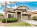 Inviting two-story home with desert landscaping, tile roof, and a spacious two car garage at 16543 W Ironwood St, Surprise, AZ 85388