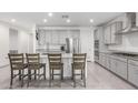 Modern kitchen featuring gray cabinetry, stainless steel appliances, and a spacious center island at 17810 W Straight Arrow Ln, Surprise, AZ 85387