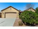 Charming single-story home with a two-car garage and landscaped front yard at 19740 W Sherman St, Buckeye, AZ 85326