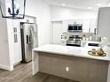 Bright kitchen featuring white cabinets, stainless steel appliances, and a quartz countertop island at 20917 N 37Th Pl, Phoenix, AZ 85050