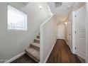 Bright hallway featuring wood-look tile flooring and a staircase with carpet at 2150 W Alameda Rd # 1122, Phoenix, AZ 85085