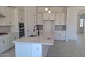 Bright kitchen features white cabinets, stainless steel appliances, a large island, and modern finishes at 24116 N 172Nd Ave, Surprise, AZ 85387