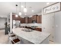 Kitchen featuring a large island, stainless steel appliances, and a view to the breakfast bar at 27878 N 175Th Dr, Surprise, AZ 85387