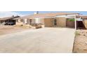 Spacious concrete driveway leading to a single-story brick home with a covered carport at 2808 W Ocotillo Rd, Phoenix, AZ 85017