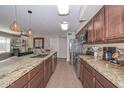 Open kitchen showcases granite countertops, stainless steel appliances, and seamless flow to dining and living areas at 3004 W Anderson Dr, Phoenix, AZ 85053