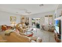 Bright living room showcasing plush seating, backyard access, and a ceiling fan at 3089 E Hazeltine Way, Chandler, AZ 85249