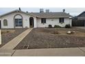 Inviting single-story home with a pathway to the front door and rock landscaping at 3646 W Mescal St, Phoenix, AZ 85029