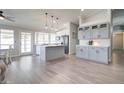 Spacious kitchen with center island, gray cabinets, stainless steel appliances, and modern pendant lighting at 372 W Larona Ln, Tempe, AZ 85284