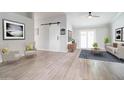 Inviting living room featuring neutral decor, hardwood floors, and bright, natural lighting at 372 W Larona Ln, Tempe, AZ 85284