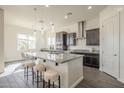 This kitchen features dark cabinets, granite countertops, a stylish island, a breakfast bar, and stainless steel appliances at 3901 S Adobe Dr, Chandler, AZ 85286