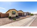 Well-maintained single-story home in a residential neighborhood with desert landscaping at 40385 W Haley Dr, Maricopa, AZ 85138